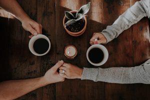 two coffees on a wooden table How to Age in a 55 and older community without losing your soul